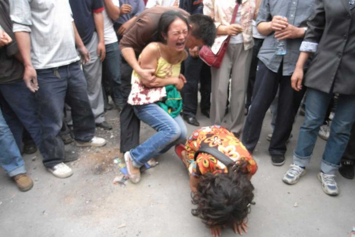 Daughters kneel and beg for their father to be rescued from a collapsed building